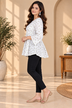 White short kurti with green floral print, flared sleeves, and gathered waist
